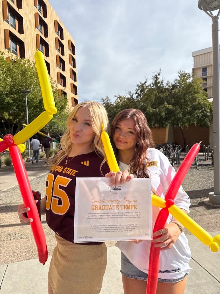 Two members celebrating a sponsored staycation prize